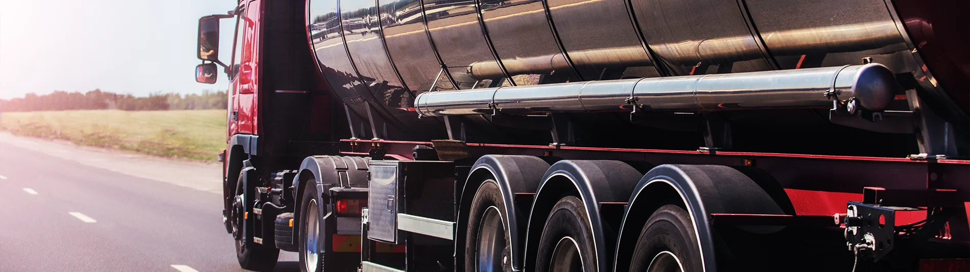 Oil tanker driving on highway.